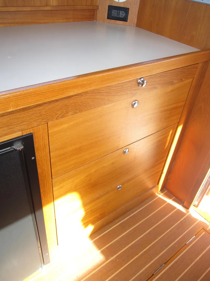Slide: The Image of Wooden cabinetry inside a 1990 Blue Seas 31 Hardtop Cruiser. - 29