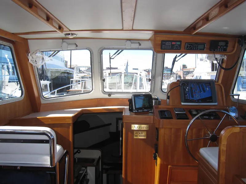 Slide: The Image of 1990 Blue Seas 31 Hardtop Cruiser interior with navigation equipment and helm station. - 32