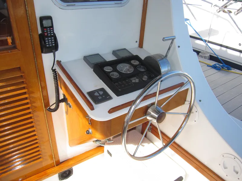 Slide: The Image of 1990 Blue Seas 31 Hardtop Cruiser helm station with steering wheel and control panel. - 35