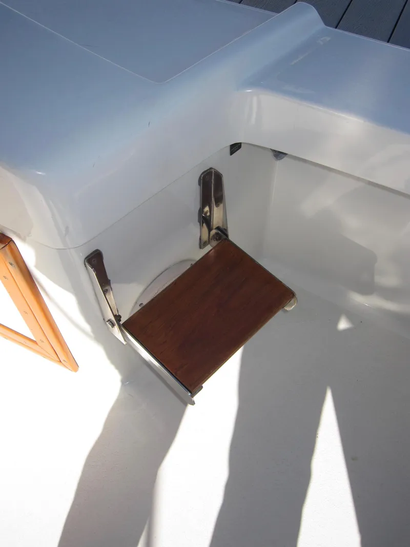 Slide: The Image of Foldable wooden seat on a 1990 Blue Seas 31 Hardtop Cruiser. - 36