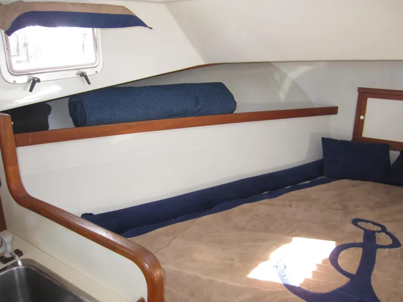 Slide: The Image of Interior cabin of a 1990 Blue Seas 31 Hardtop Cruiser with bed and porthole. - 4