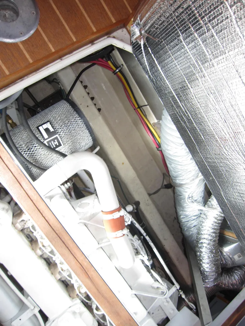 Slide: The Image of Engine compartment of 1990 Blue Seas 31 Hardtop Cruiser with visible wiring and ductwork. - 49
