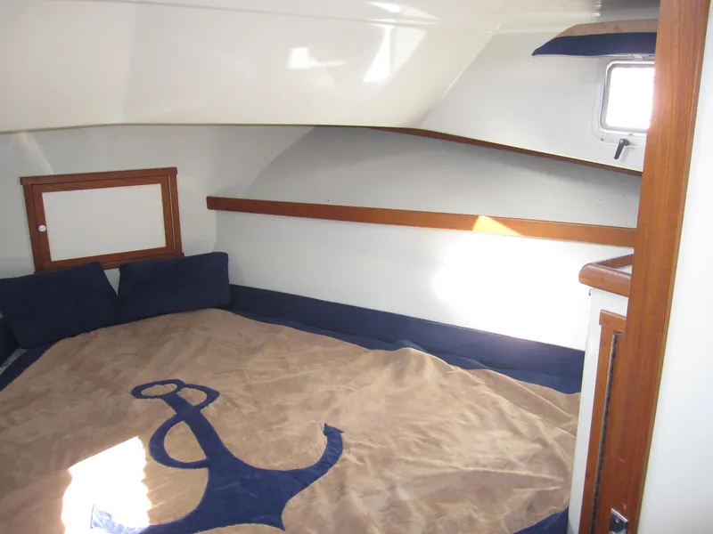 Slide: The Image of Interior cabin of a 1990 Blue Seas 31 Hardtop Cruiser with anchor-themed bedding. - 5