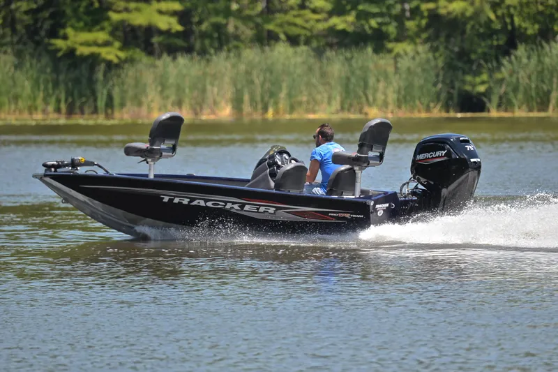 Slide: The Image of 2021 Bass Tracker PRO TEAM 175 TF boat cruising on a lake. - 4