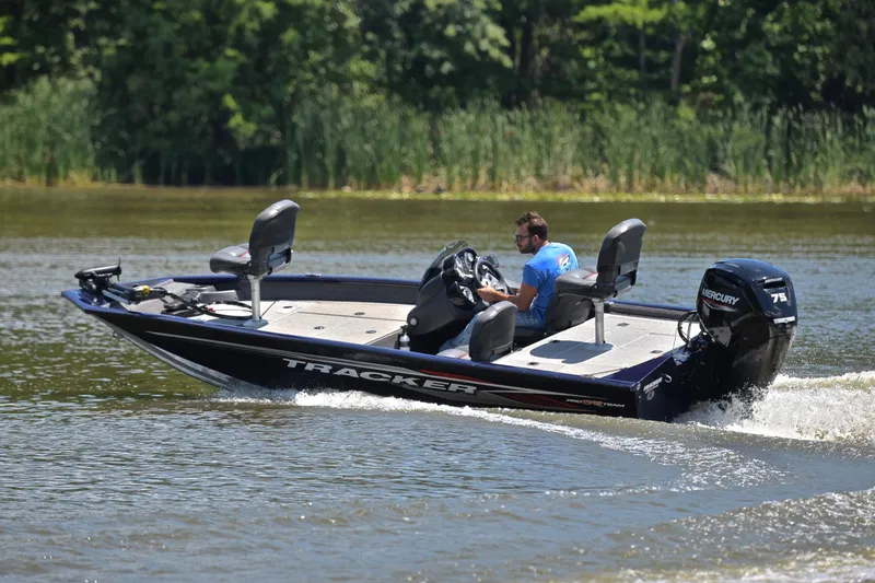 Slide: The Image of 2021 Bass Tracker PRO TEAM 175 TF boat cruising on a lake. - 6