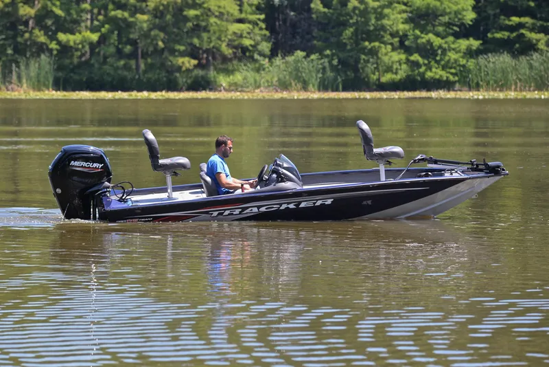 Slide: The Image of 2021 Bass Tracker PRO TEAM 175 TF fishing boat on a calm lake. - 7