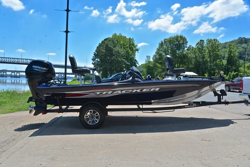 Slide: The Image of 2021 Bass Tracker PRO TEAM 175 TF boat on a trailer by a river. - 15