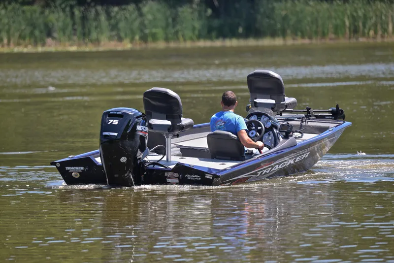 Slide: The Image of 2021 Bass Tracker PRO TEAM 175 TF boat on a calm lake. - 8