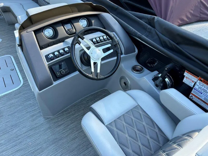 Slide: The Image of 2022 Bennington 26LXFB boat cockpit with steering wheel and control panel. - 4