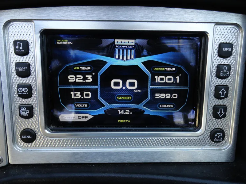Slide: The Image of MasterCraft X-10 2013 dashboard display showing air and water temperature, speed, and other metrics. - 10