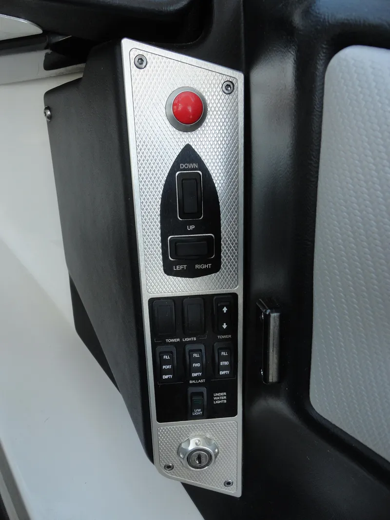 Slide: The Image of Control panel of a 2013 MasterCraft X-10 boat with various switches and buttons. - 11
