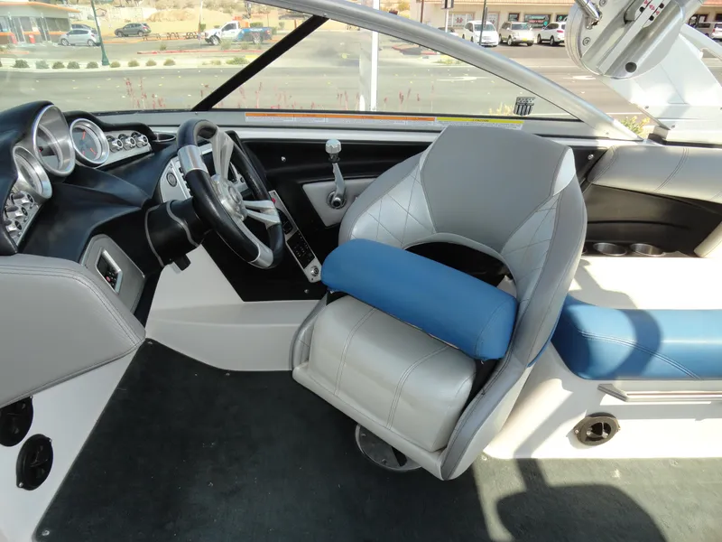 Slide: The Image of 2013 MasterCraft X-10 boat interior with steering wheel and captain's chair. - 13