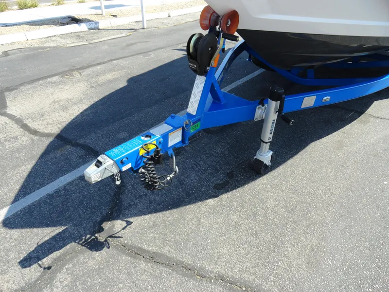 Slide: The Image of 2013 MasterCraft X-10 boat trailer hitch and support stand in a parking lot. - 23