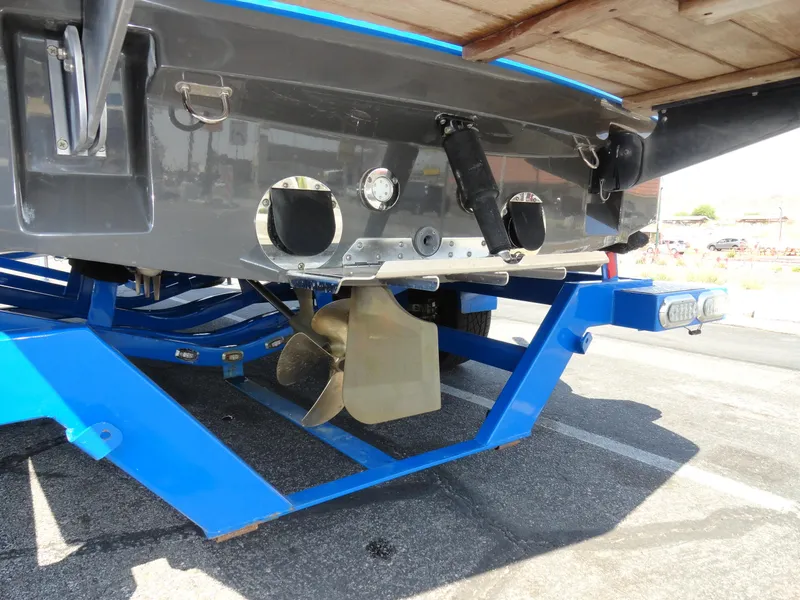 Slide: The Image of 2013 MasterCraft X-10 boat on blue trailer, showing propeller and underside details. - 26