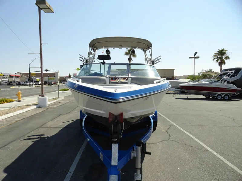 Slide: The Image of 2013 MasterCraft X-10 boat on a trailer in a parking lot. - 3