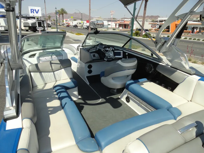 Slide: The Image of 2013 MasterCraft X-10 boat interior with blue and white seating, dashboard, and steering wheel. - 7