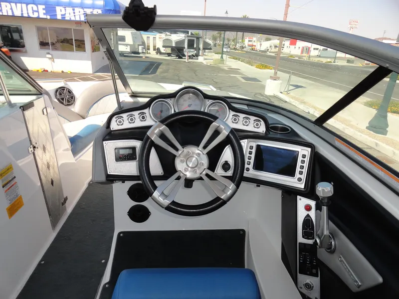 Slide: The Image of 2013 MasterCraft X-10 boat dashboard with steering wheel and control panel. - 8