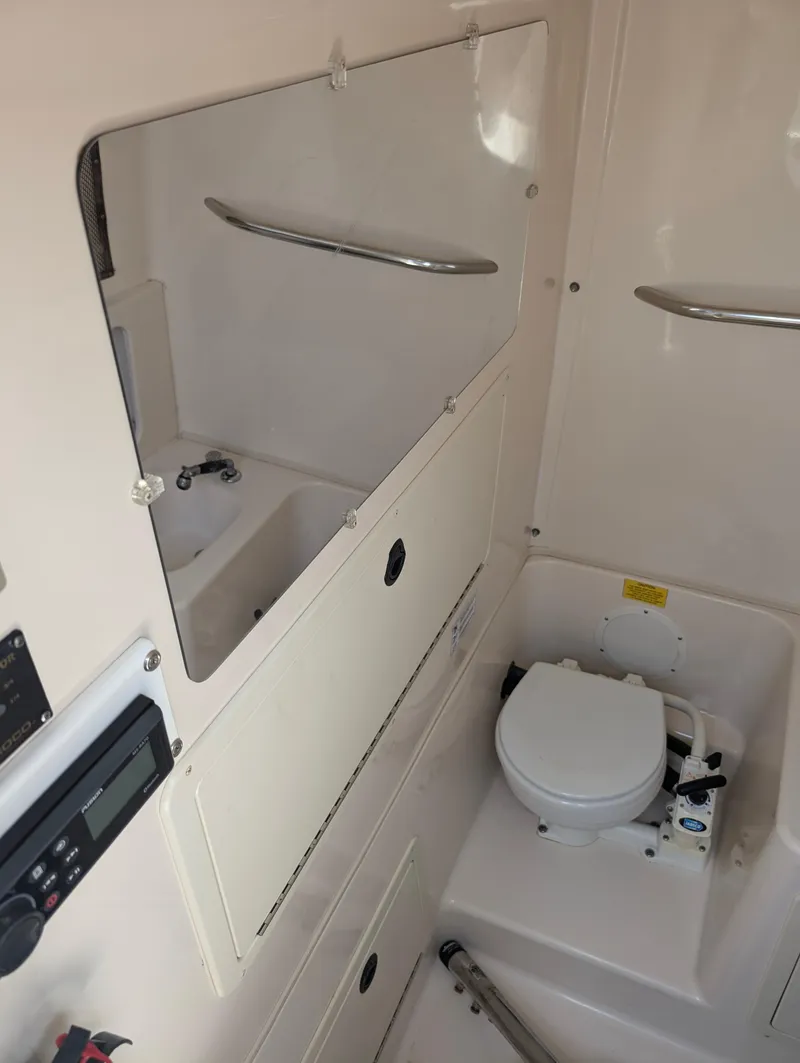Slide: The Image of 2000 Grady-White Bimini 306 boat interior with toilet and storage compartments. - 10