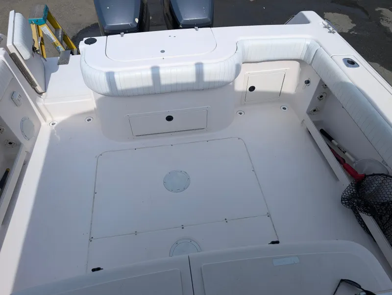 Slide: The Image of 2000 Grady-White Bimini 306 boat deck with seating and storage compartments. - 13