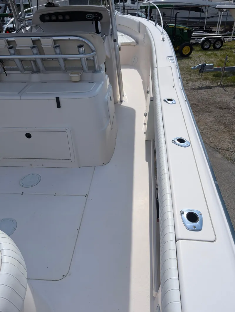 Slide: The Image of 2000 Grady-White Bimini 306 boat deck with rod holders and seating. - 18