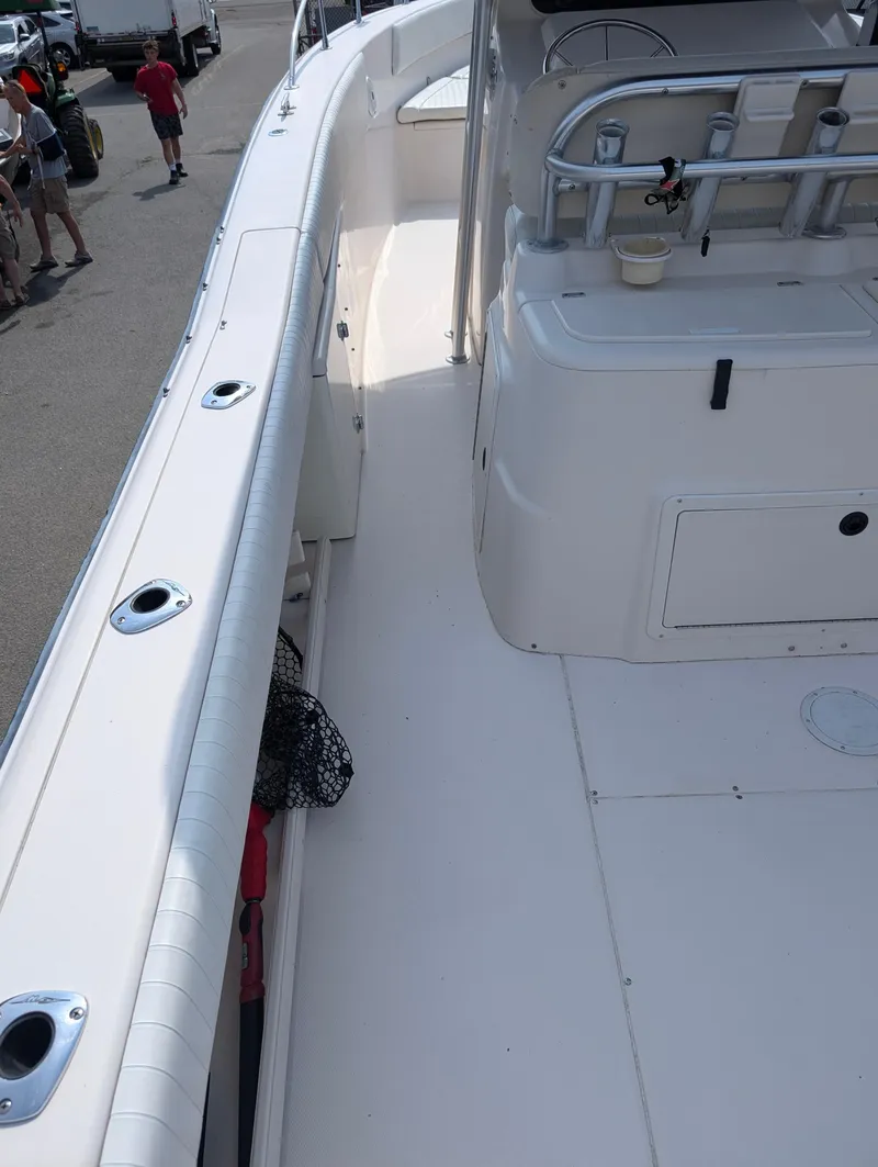 Slide: The Image of 2000 Grady-White Bimini 306 boat deck with rod holders and storage compartments. - 19