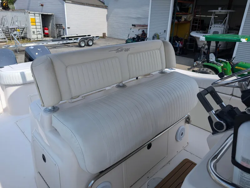 Slide: The Image of Grady-White Bimini 306 2000 boat interior with white cushioned seating and control panel. - 21