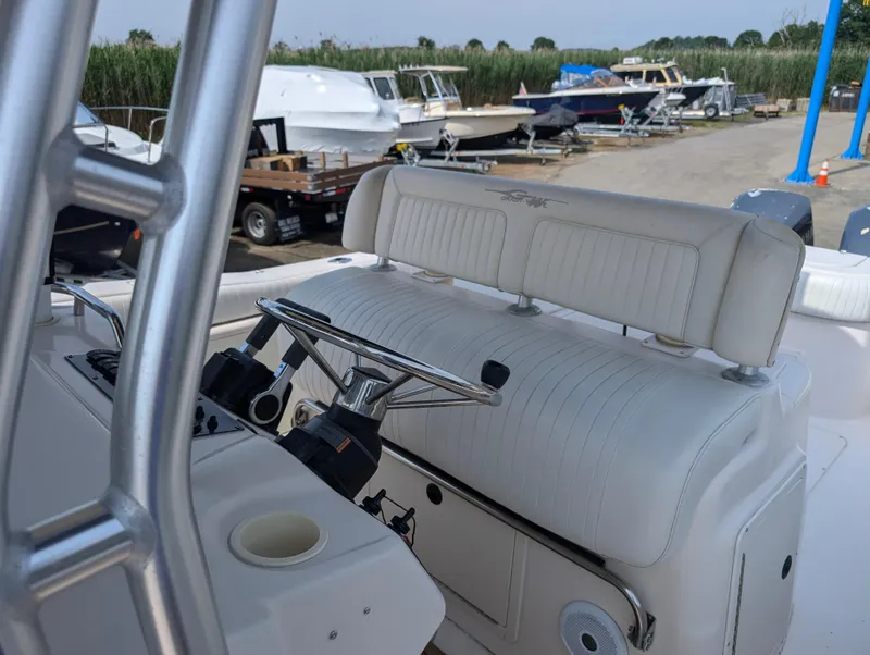 Slide: The Image of 2000 Grady-White Bimini 306 boat cockpit with steering wheel and seating. - 22