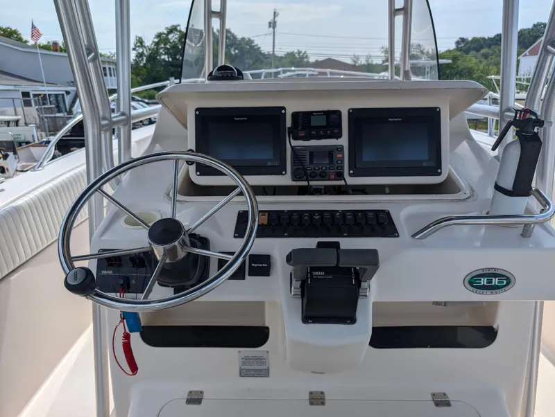 Slide: The Image of Grady-White Bimini 306 2000 boat helm with dual screens and steering wheel. - 24