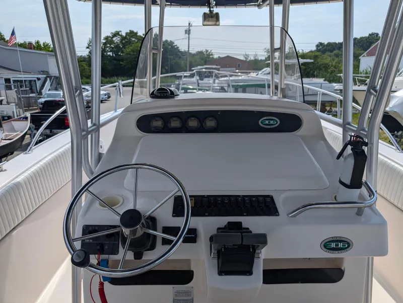 Slide: The Image of 2000 Grady-White Bimini 306 boat dashboard with steering wheel and controls. - 25