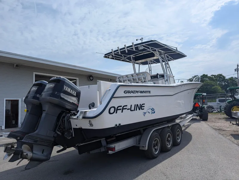 Slide: The Image of 2000 Grady-White Bimini 306 boat on a trailer with twin Yamaha engines. - 3