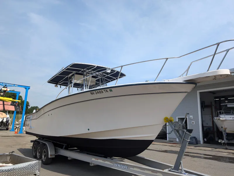 Slide: The Image of 2000 Grady-White Bimini 306 boat on a trailer in a marina. - 4