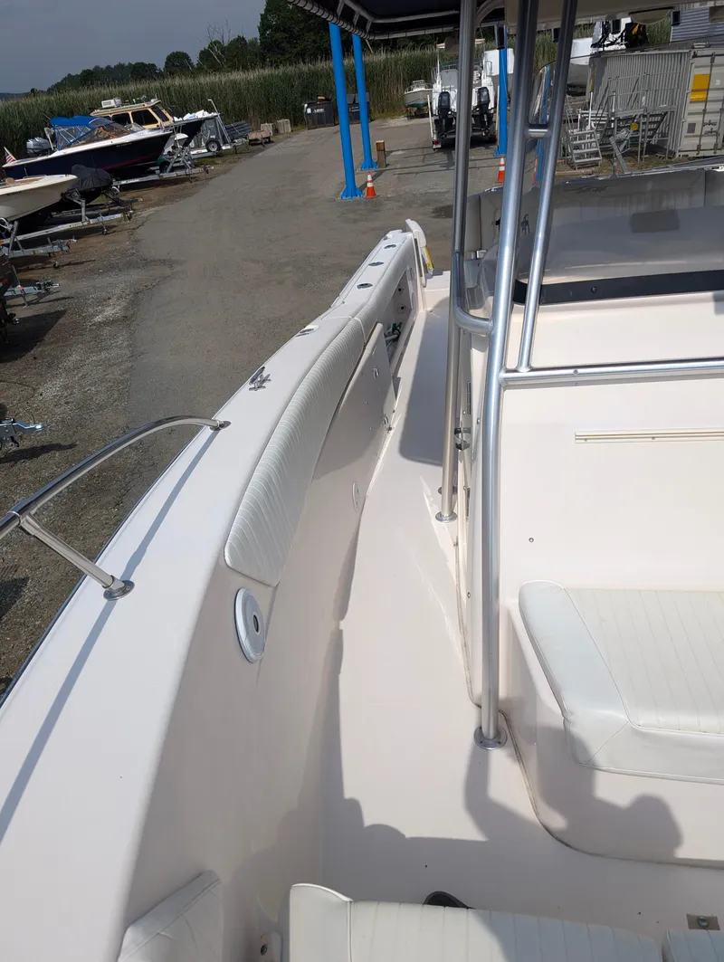 Slide: The Image of 2000 Grady-White Bimini 306 boat interior, docked with other boats in the background. - 7