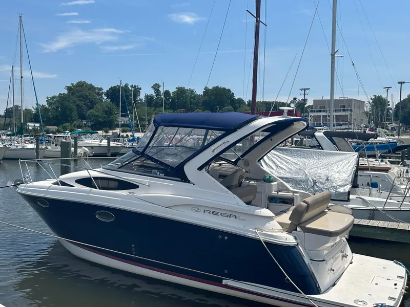 Slide: The Image of 2014 Regal 30 Express boat docked at a marina. - 0