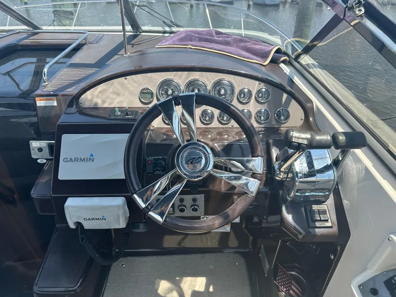 Slide: The Image of 2014 Regal 30 Express boat helm with Garmin navigation system and control panel. - 11