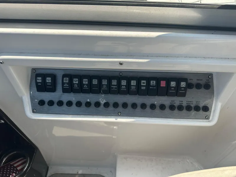 Slide: The Image of Control panel of a 2014 Regal 30 Express boat with various switches and buttons. - 12