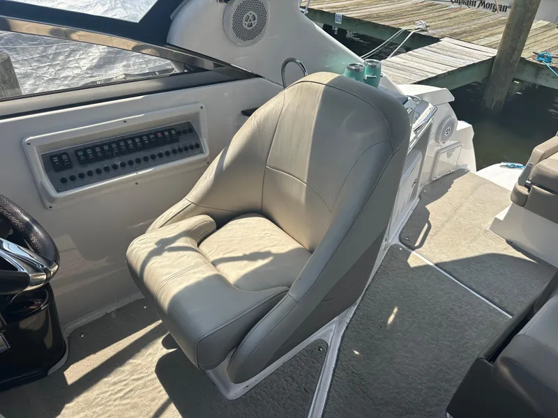 Slide: The Image of Captain's chair and control panel on a 2014 Regal 30 Express boat. - 14