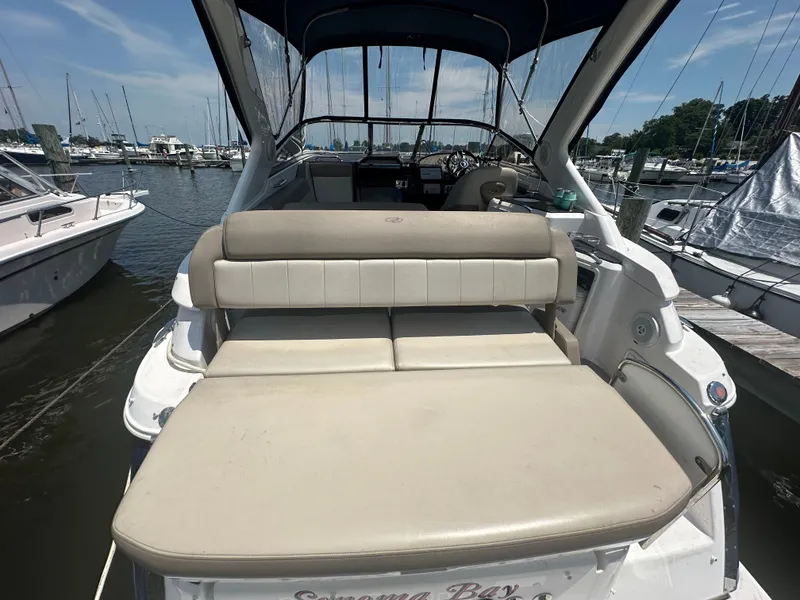 Slide: The Image of 2014 Regal 30 Express boat with beige seating at a marina. - 16