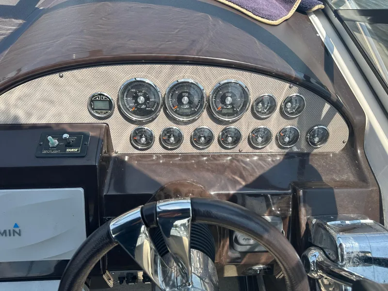 Slide: The Image of 2014 Regal 30 Express boat dashboard with gauges and controls. - 17