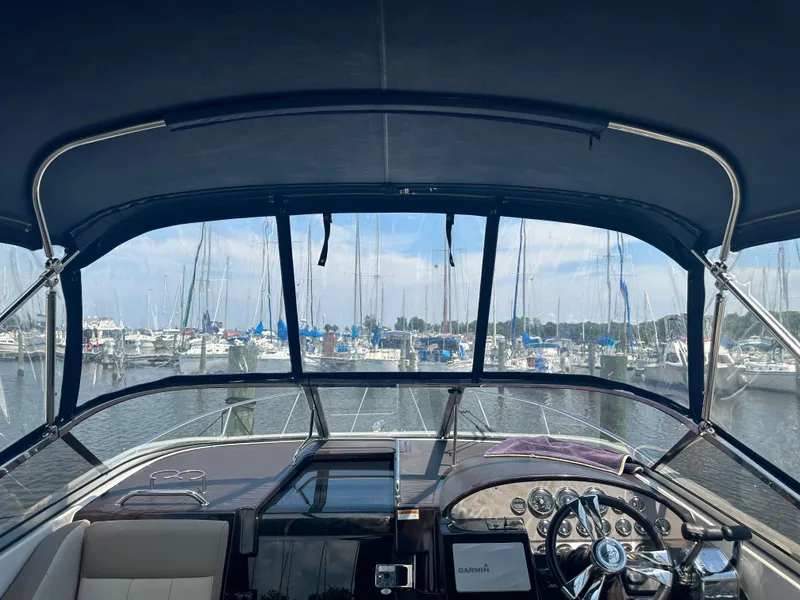 Slide: The Image of View from the helm of a 2014 Regal 30 Express boat docked at a marina. - 19