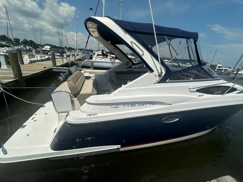 Slide: The Image of 2014 Regal 30 Express boat docked at a marina on a sunny day. - 3