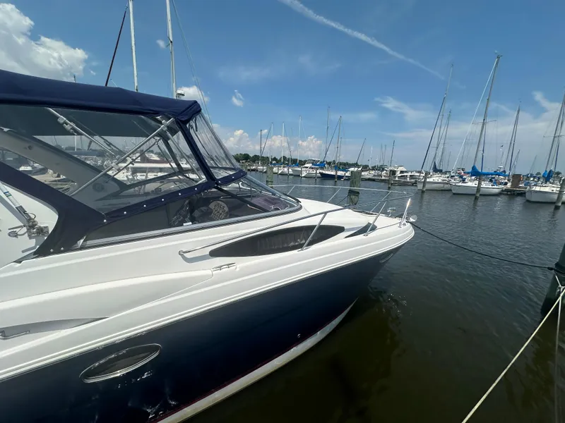 Slide: The Image of 2014 Regal 30 Express boat docked at a marina on a sunny day. - 4