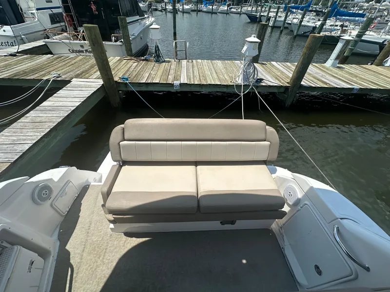Slide: The Image of 2014 Regal 30 Express boat with cushioned seating at the dock. - 7