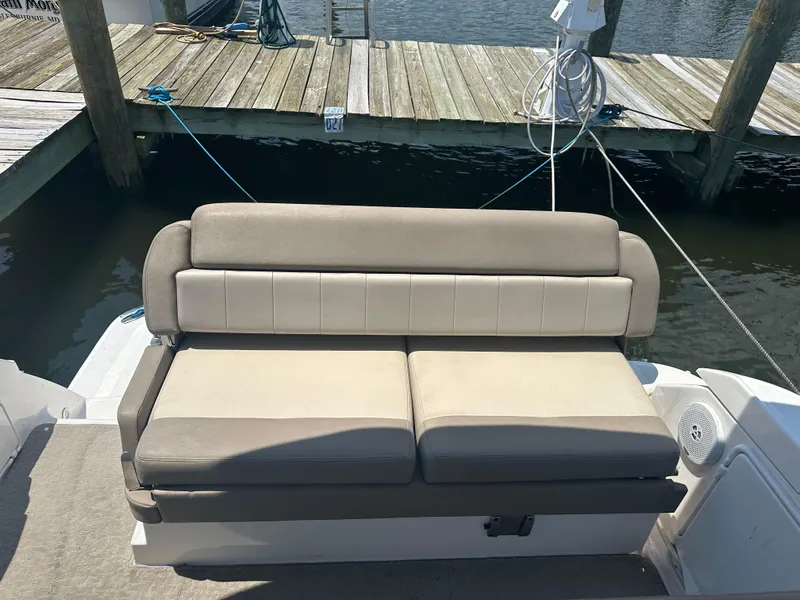 Slide: The Image of Rear seating area of a 2014 Regal 30 Express boat docked at a marina. - 8