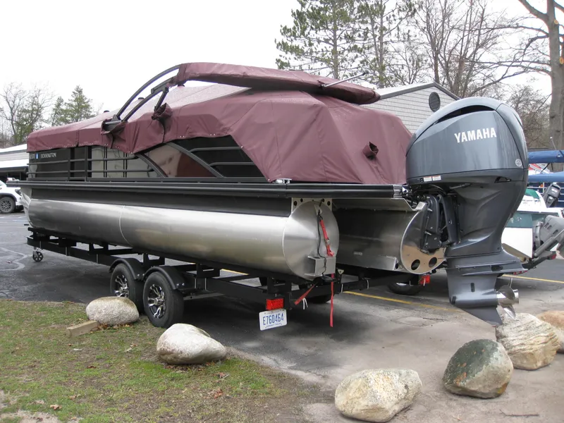 Slide: The Image of 2021 Bennington 23RFBSD pontoon boat with Yamaha outboard motor on trailer. - 2