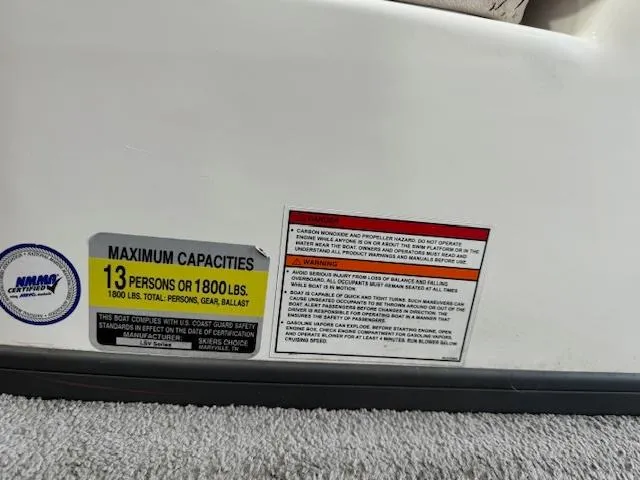 Slide: The Image of 2007 Moomba Mobius LSV boat capacity label, 13 persons or 1800 lbs, safety warnings. - 11