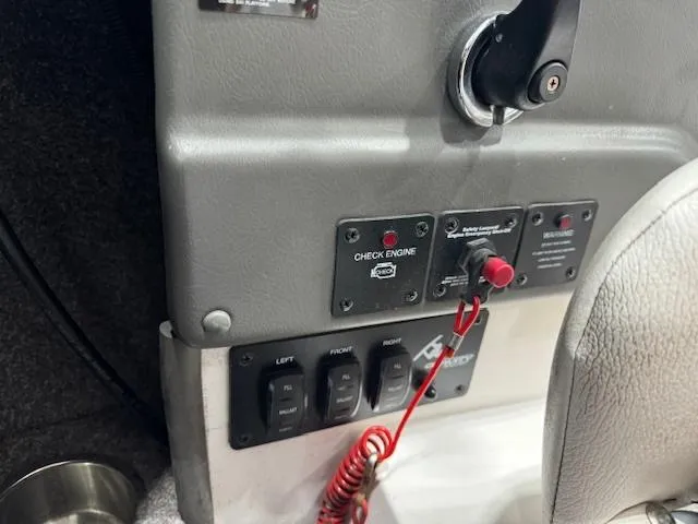 Slide: The Image of 2007 Moomba Mobius LSV boat dashboard with engine check and control switches. - 12