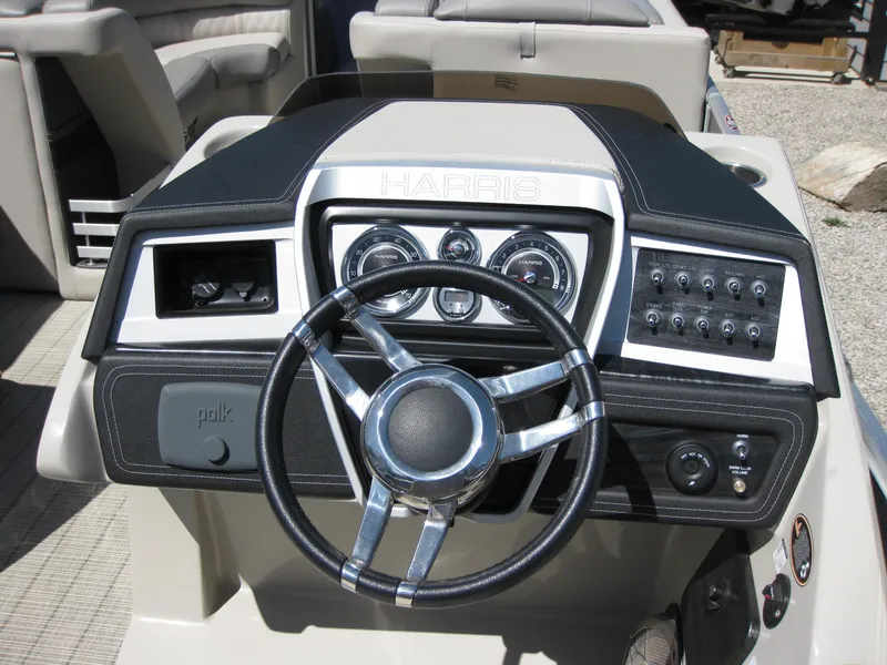 Slide: The Image of 2019 Harris Grand Mariner 250 boat dashboard with steering wheel and control panel. - 3