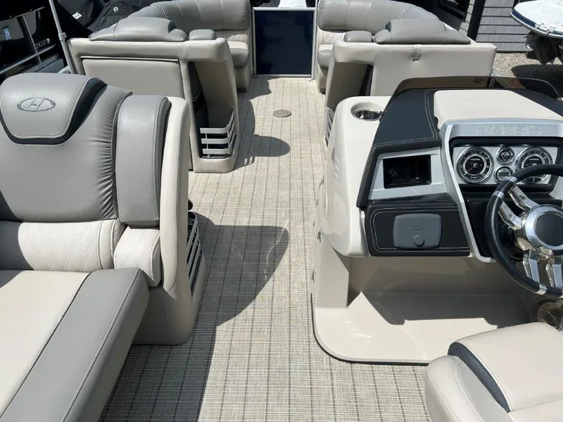 Slide: The Image of 2019 Harris Grand Mariner 250 boat interior with luxurious seating and modern dashboard. - 4