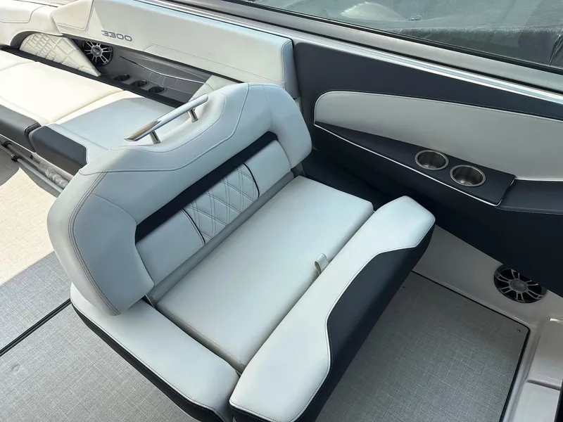 Slide: The Image of 2025 Regal 3300 boat interior with luxurious seating and cup holders. - 10