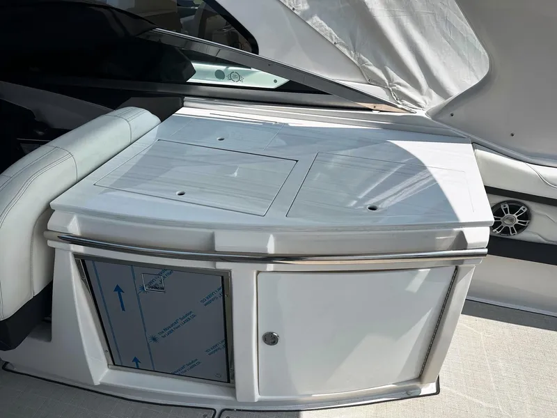 Slide: The Image of 2025 Regal 3300 boat interior with sleek white cabinetry and seating. - 5